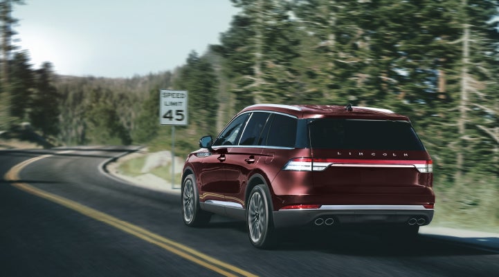 A 2024 Lincoln Aviator® SUV is being driven on a winding mountain road | McLarty Daniel Lincoln in Bentonville AR