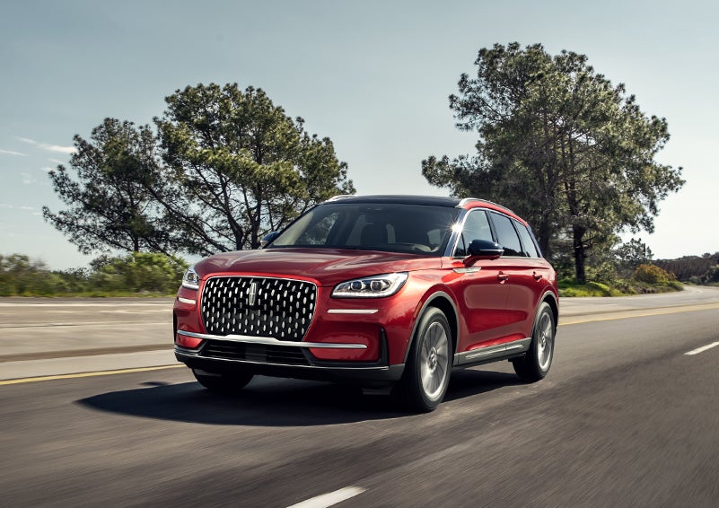A 2024 Lincoln Corsair® SUV is shown being driven on a country road. | McLarty Daniel Lincoln in Bentonville AR