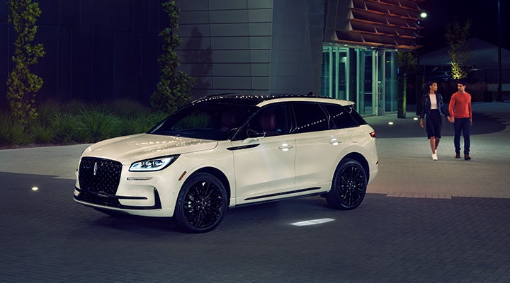 Two people approach a 2024 Lincoln Corsair® SUV featuring the available Jet Appearance Package. | McLarty Daniel Lincoln in Bentonville AR