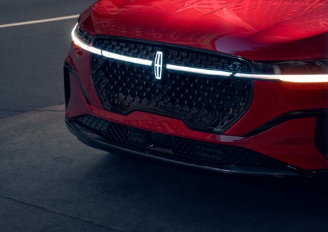 The available front LED light bar and center Lincoln Star logo glow at dusk. | McLarty Daniel Lincoln in Bentonville AR