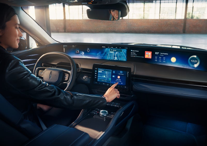 The driver of a 2025 Lincoln Nautilus® SUV interacts with the center touchscreen. | McLarty Daniel Lincoln in Bentonville AR