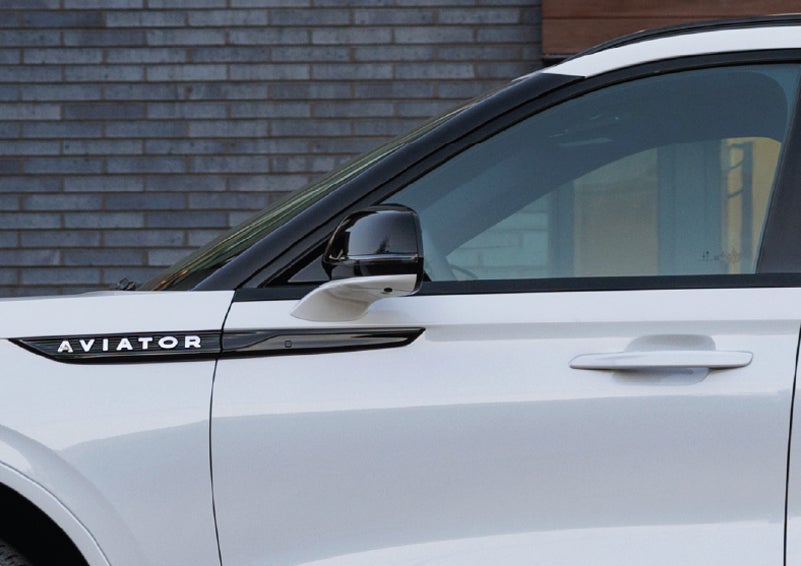 The driver’s side door and fender badging of a white 2026 Lincoln Aviator® SUV are showcased. | McLarty Daniel Lincoln in Bentonville AR