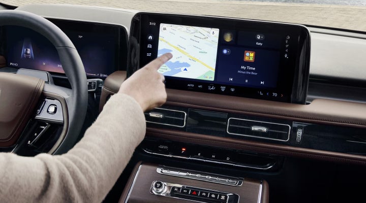 A person is tapping the center display touchscreen of a 2026 Lincoln Aviator® SUV. | McLarty Daniel Lincoln in Bentonville AR