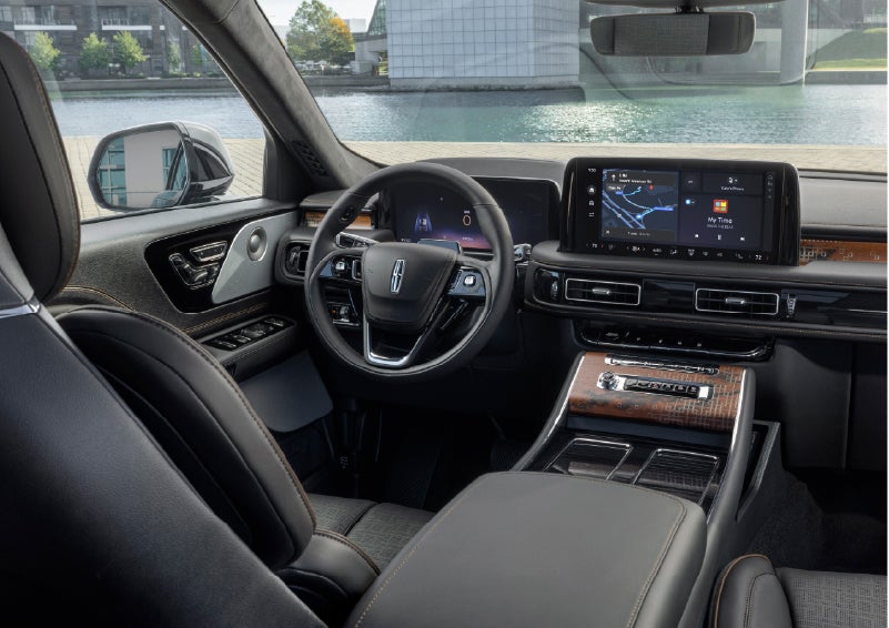 The interior of the 2026 Lincoln Aviator® SUV is shown parked with a view of a harbor through the windshield. | McLarty Daniel Lincoln in Bentonville AR