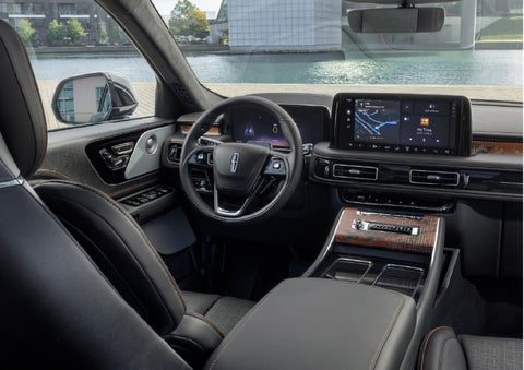 The interior of the 2026 Lincoln Aviator® SUV is shown parked with a view of a harbor through the windshield. | McLarty Daniel Lincoln in Bentonville AR
