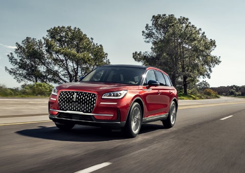 A 2026 Lincoln Corsair® SUV is shown being driven on a country road. | McLarty Daniel Lincoln in Bentonville AR