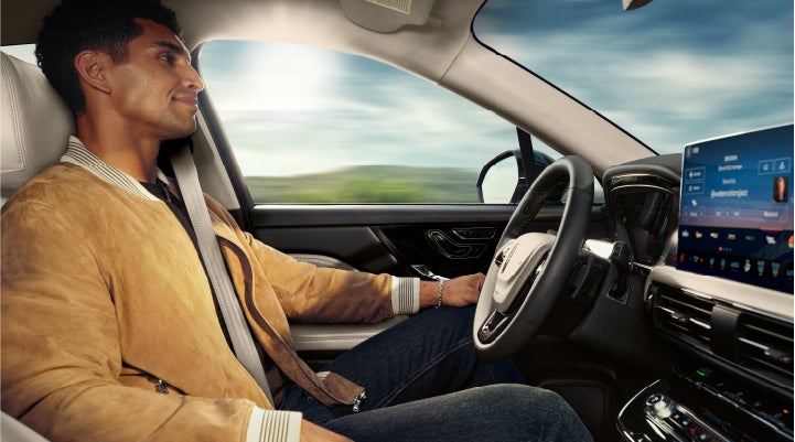 A person is shown using Lincoln BlueCruise hands-free highway driving technology on a divided highway in a hands-free Blue Zone. | McLarty Daniel Lincoln in Bentonville AR