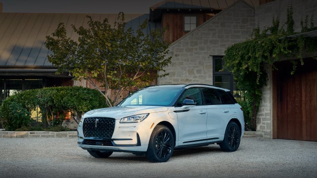 A 2026 Lincoln Corsair® SUV is parked in front off a luxury home. | McLarty Daniel Lincoln in Bentonville AR