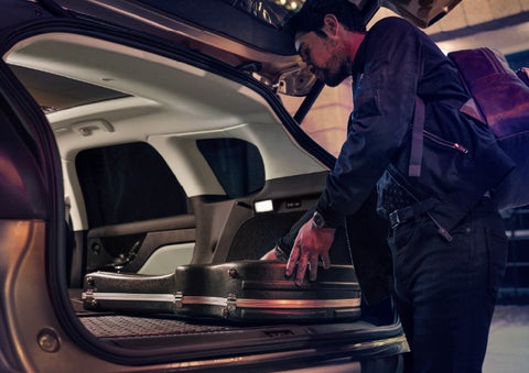 A man is shown loading cargo into the rear of a 2026 Lincoln Corsair® SUV with the second-row seats folded flat. | McLarty Daniel Lincoln in Bentonville AR