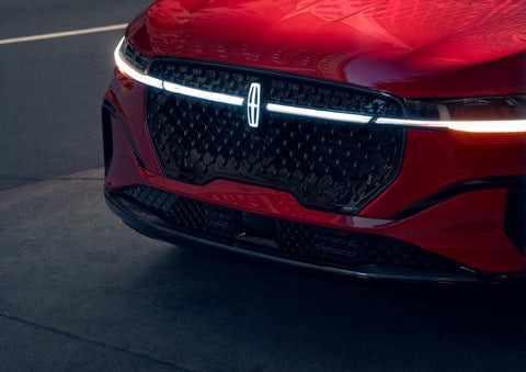 The available front LED light bar and center Lincoln Star logo glow at dusk. | McLarty Daniel Lincoln in Bentonville AR