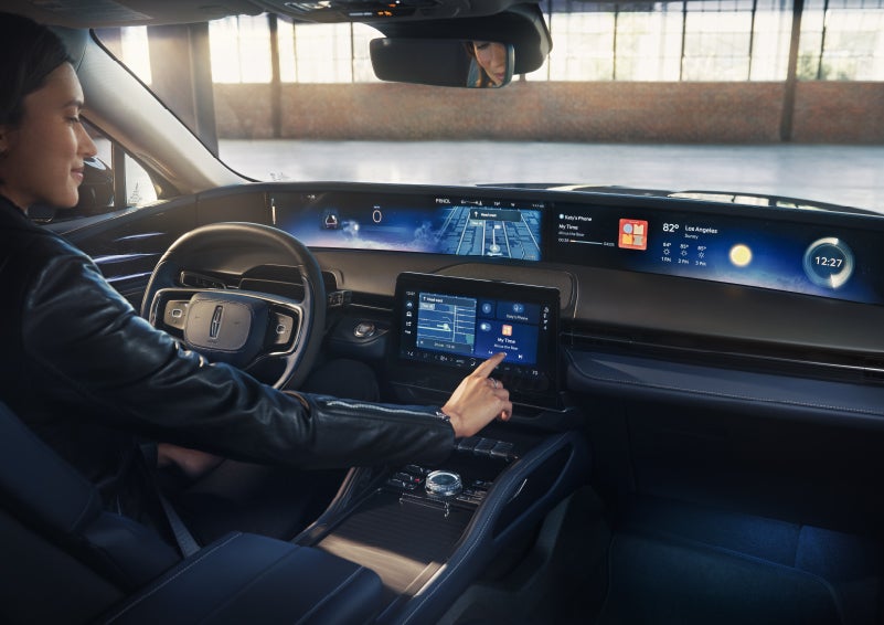 The driver of a 2026 Lincoln Nautilus® SUV interacts with the center touchscreen. | McLarty Daniel Lincoln in Bentonville AR