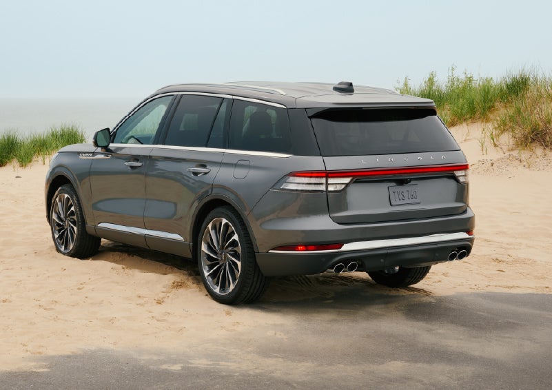 A 2027 Lincoln Aviator® SUV is parked next to sand dunes. | McLarty Daniel Lincoln in Bentonville AR
