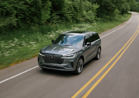 A 2027 Lincoln Aviator® SUV is being driven down a road. | McLarty Daniel Lincoln in Bentonville AR