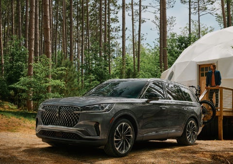 A 2027 Lincoln Aviator® is parked next to a high end glamping site. | McLarty Daniel Lincoln in Bentonville AR