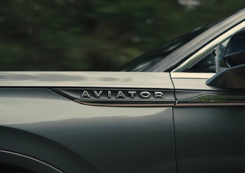 The driver’s side door and fender badging of a gray 2027 Lincoln Aviator® SUV are showcased. | McLarty Daniel Lincoln in Bentonville AR