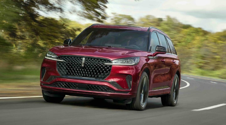 A 2027 Lincoln Aviator® SUV is being driven on a country road | McLarty Daniel Lincoln in Bentonville AR