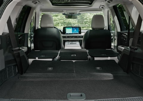 A rear to front view of the interior of a 2027 Lincoln Aviator® Black Label™ SUV shows the third and second rows folded flat | McLarty Daniel Lincoln in Bentonville AR