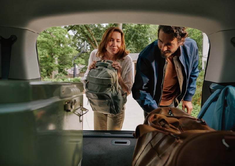 A couple loads luggage into the rear of a 2027 Lincoln Aviator® Black Label™ SUV..e 202 | McLarty Daniel Lincoln in Bentonville AR